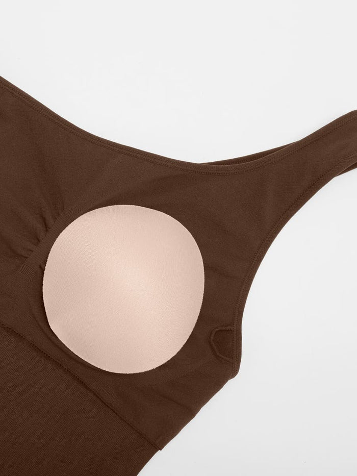 Shaping jumpsuit with asymmetric straps and flared legs